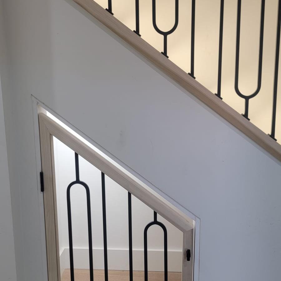 Custom hardwood staircase with iron balusters